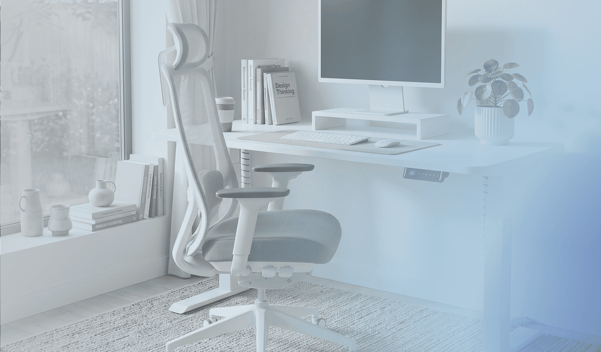 ergonomic home office setup with a height adjustable standing desk and ergonomic chair