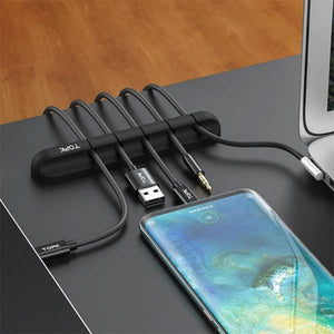 Phone with multiple cables and a cable organizer on a desk