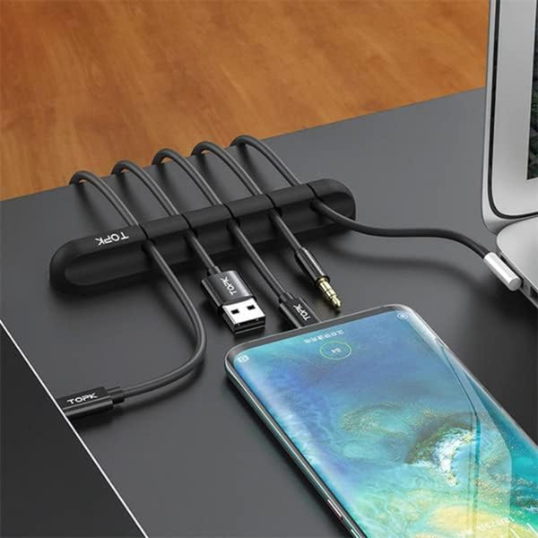 Phone with multiple cables and a cable organizer on a desk