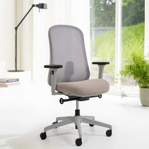 Gray office chair in a bright room with a lamp and books on a white surface.