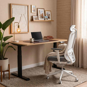 Home office setup with a desk, chair, laptop, and decor elements.