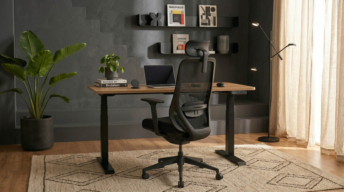 Modern office setup with a stand-up desk, chair, and decor elements.