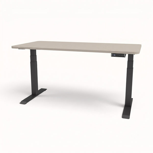 An adjustable standing desk with a light beige rectangular tabletop and a dark gray metal frame with dual legs and a control panel.