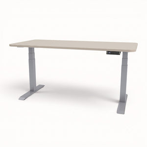 An adjustable height standing desk with a light beige wood-grain top and gray metal legs, shown on a clean white background.