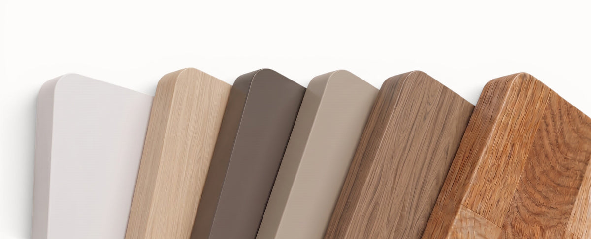 Six rounded rectangular wood-look sample panels in different colors and finishes, fanned out against a plain white background.