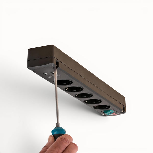 Power strip with multiple outlets being adjusted with a screwdriver on a white background